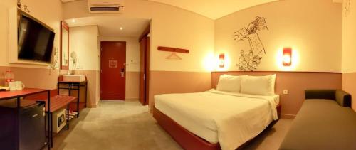 um quarto de hotel com uma cama e uma secretária em Kotta GO Yogyakarta em Yogyakarta