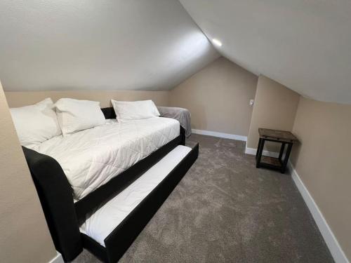 a bedroom with a large bed with a couch at Snug, neighborly home perfect for your small group in Billings