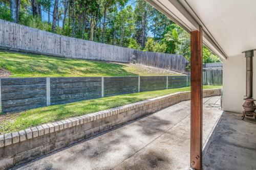a view of a fence from a patio at Castaway Cottage - Rainbow Beach in Rainbow Beach