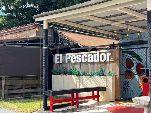 a park bench sitting in front of a restaurant at Casa Rosado Villa Marina Fajardo Yunque Seven Seas in Fajardo