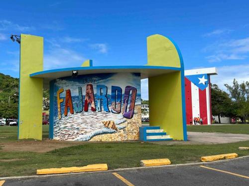 a building with a painting on it in a parking lot at Casa Rosado Villa Marina Fajardo Yunque Seven Seas in Fajardo