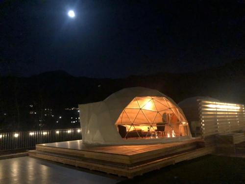 a igloo building at night with the moon in the background at Matsukaneya Annex in Zao Onsen