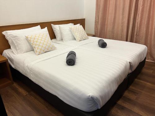 a bed with two slippers on top of it at NEW 6pax 3BR Sunrise view 100m Attractive Places Kea Farm in Cameron Highlands