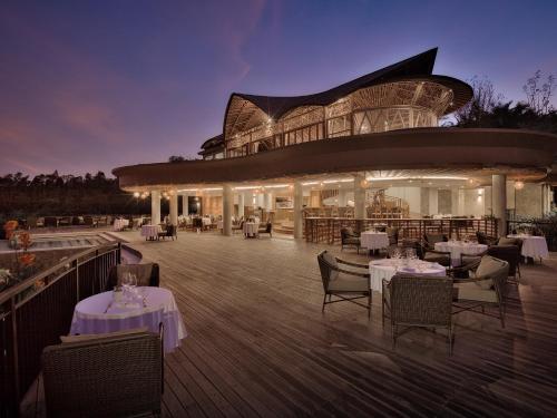 a restaurant with tables and chairs in front of a building at Elevate Bali in Munduk