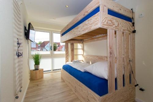 a bedroom with a wooden bunk bed in a room at Marina 20-D in Cuxhaven