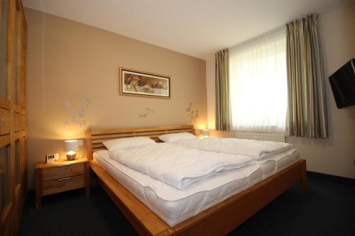 - un grand lit dans une chambre avec fenêtre dans l'établissement Kurpark-Residenz 132, à Döse
