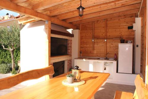 a kitchen and dining room with a wooden ceiling at Villa Divine in Vodice