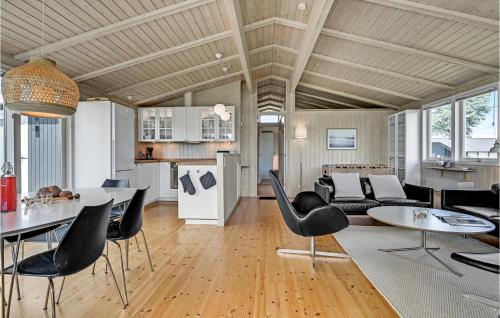 a kitchen and living room with a table and chairs at Amazing Home In Malling With Kitchen in Malling