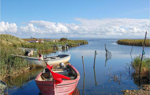 two boats are docked in the water on a lake at 3 Bedroom Amazing Home In Hvide Sande in Havrvig