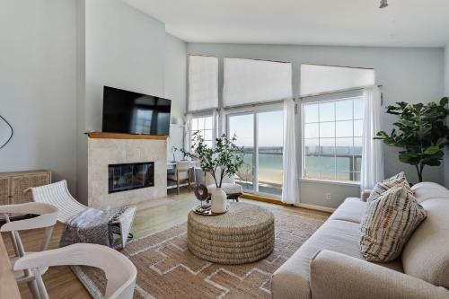 a living room with a couch and a fireplace at @ Marbella Lane – Home with Majestic Ocean Views in Pacifica