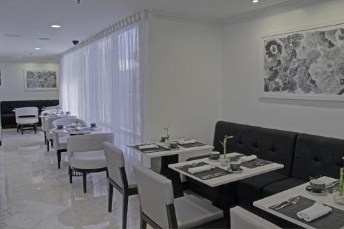 a restaurant with tables and chairs and a couch at Intercontinental Real Guatemala by IHG in Guatemala