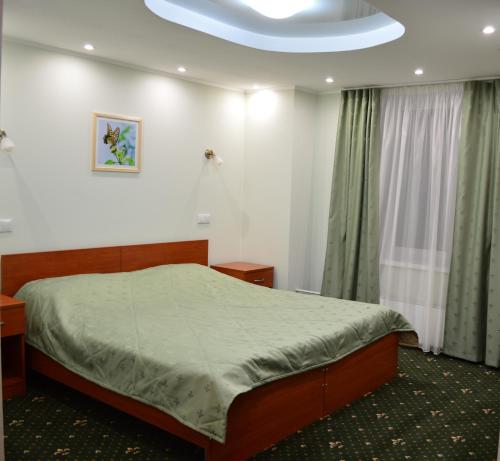 a bedroom with a bed in a room at Park Vista in Yekaterinburg