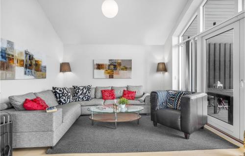 a living room with a couch and a chair at Cozy Home In Rudkøbing With Wifi in Spodsbjerg
