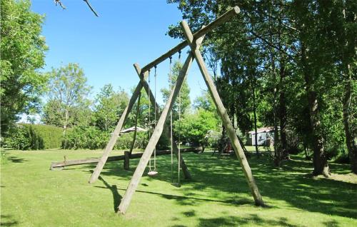 a wooden swing set in a park at Nice Home In Nexø With Kitchen in Neksø