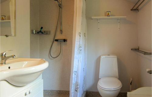 a bathroom with a toilet and a sink at Nice Home In Nex With Kitchen in Neksø