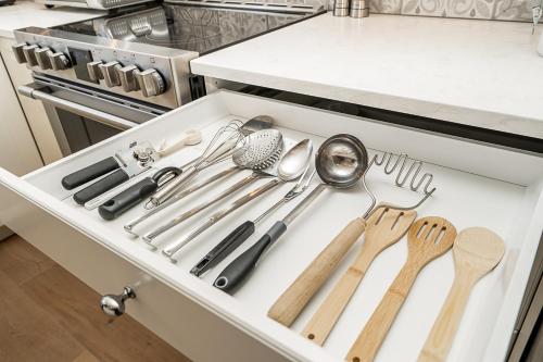a drawer filled with cooking utensils in a kitchen at Comfortable and Modern Rowhouse Perfect for BC Escapade, air conditioned in Langley