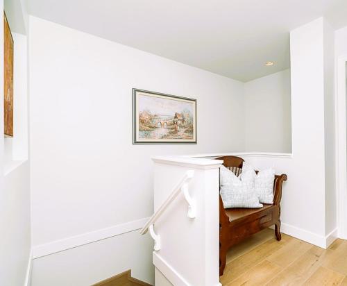 a white staircase in a home with white walls at Comfortable and Modern Rowhouse Perfect for BC Escapade, air conditioned in Langley