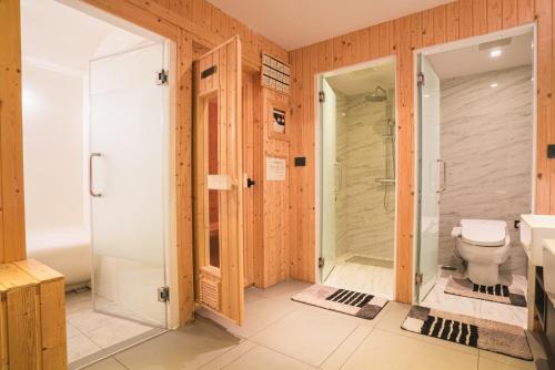 a bathroom with a toilet and a shower at VOQUE Hotel & Serviced Residence Sukhumvit 51 - SHA Plus in Bangkok