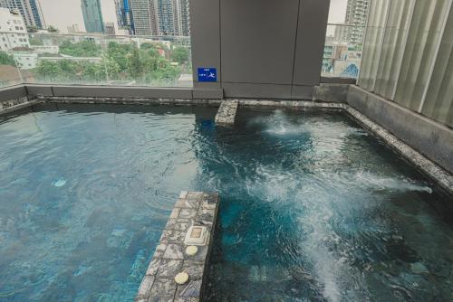 a large pool of water in a building at VOQUE Hotel & Serviced Residence Sukhumvit 51 in Bangkok