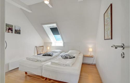 a white room with two beds and a window at Awesome Apartment In Lemvig With Kitchen in Lemvig