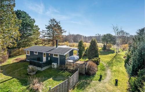 a blue tiny house in the middle of a yard at Gorgeous Home In Gilleleje in Gilleleje