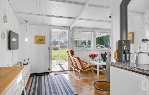 a kitchen with white walls and a table and chairs at Gorgeous Home In Gilleleje in Gilleleje