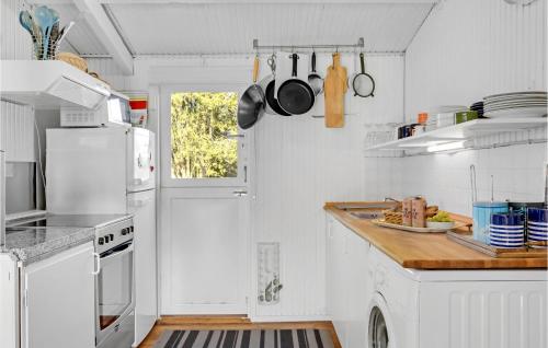 a kitchen with white appliances and a white door at Gorgeous Home In Gilleleje in Gilleleje