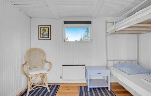 a bedroom with a bed and a chair and a desk at Gorgeous Home In Gilleleje in Gilleleje
