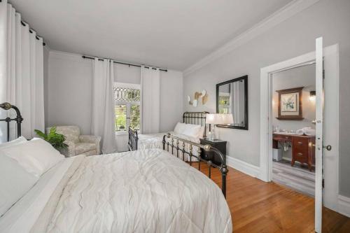 a white bedroom with a bed and a desk at Entire Main level of Beautiful Historic Home in Spokane