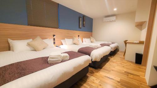 a hotel room with two beds in a room at Sapporo - House - Vacation STAY 88291 in Sapporo