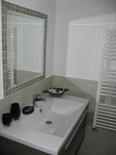 a bathroom with a white sink and a mirror at Hotel e trattoria San Giorgio in Piossasco