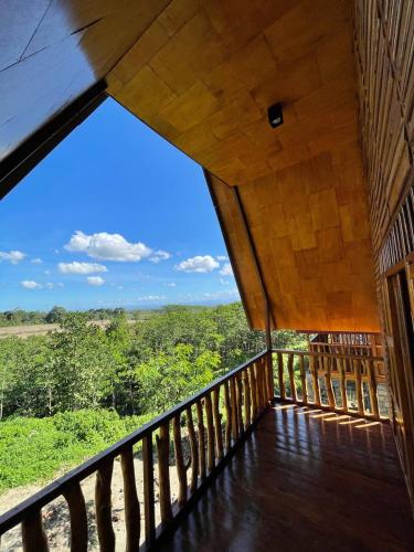 a balcony with a view of the forest at Vila Glamping Lembah Kelud Kediri in Berni