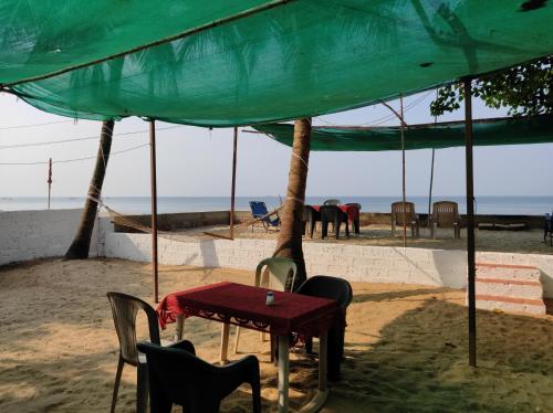 a table and chairs under a tent on the beach at Samsun Pride in Chaoka