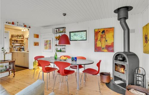 a living room with a table and a wood stove at Nice Home In Grevinge With Wifi in Grevinge