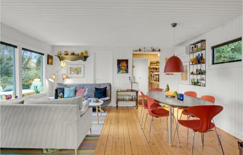 a living room with a couch and a table and chairs at Nice Home In Grevinge With Wifi in Grevinge