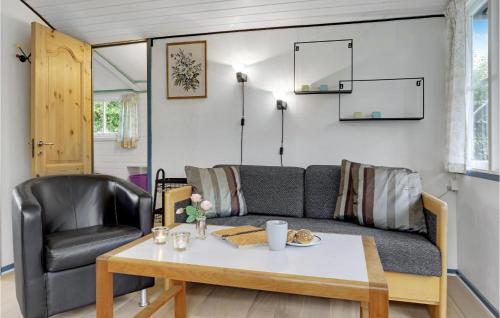 a living room with a couch and a table at Pet Friendly Home In Nexø With Wifi in Neksø