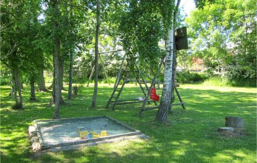 a park with a swing set in the grass at Pet Friendly Home In Nexø With Wifi in Neksø