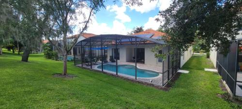 an image of a house with a swimming pool at Cheerful 4bed 3bath with pool home near Disney in Kissimmee