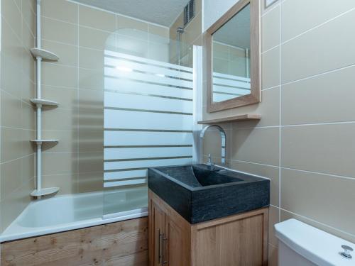 a bathroom with a sink and a mirror and a tub at Appartement La Plagne, 2 pièces, 4 personnes - FR-1-351-80 in La Plagne