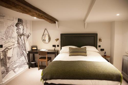 a bedroom with a bed and a desk with a drawing on the wall at Judges Court in York