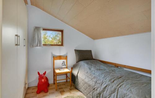 a bedroom with a bed and a red dog in it at Stunning Home In Mern With Kitchen in Mern