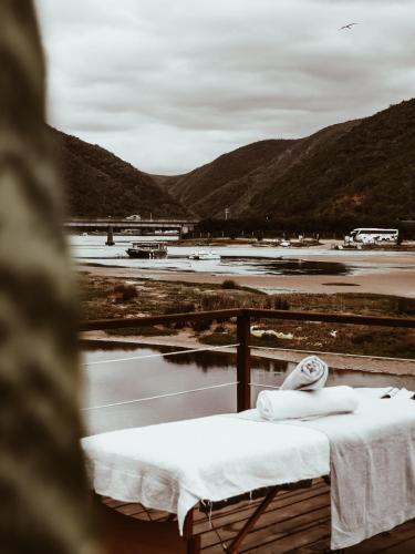 a table with towels on it with mountains in the background at Stanley Island in Plettenberg Bay