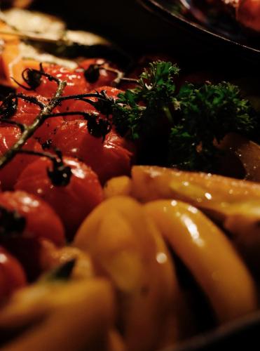 a close up of a plate of food with tomatoes and broccoli at The Nook Hotel Hangzhou - A design hotel, 20 mins to West Lake and Lingyin Temple in Hangzhou