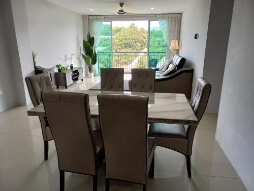 a dining room with a table and chairs at Nature Stay Cameron Highlands in Cameron Highlands