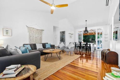 a living room with a couch and a table at Bon Cottage in Woorim