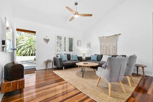 a living room with a couch and a table at Bon Cottage in Woorim
