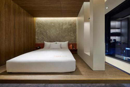 a large white bed in a room with a window at N285 Hotel Insadong in Seoul