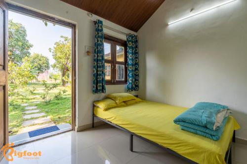 a bedroom with a bed and a large window at Ellow Stay by Mohan farm, Khopoli in Jambhulpāda