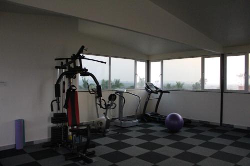 a gym with two treadmills and exercise bikes at Flamingo Club and Resort Una 3 Km Away from Diu Check Post in Diu