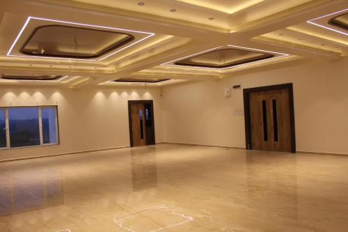 a large empty room with a ceiling with lights at Flamingo Club and Resort Una 3 Km Away from Diu Check Post in Diu